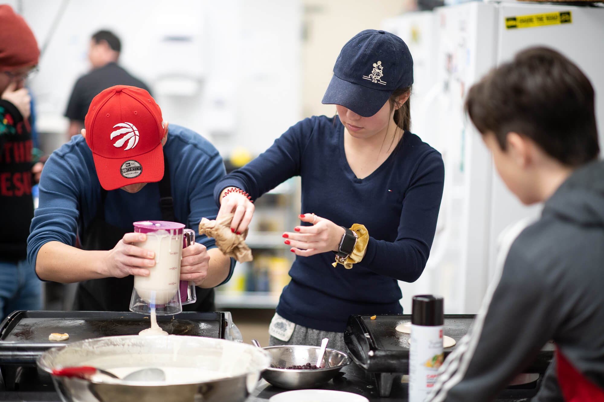 Group of people making pancakes at Next Door Social Space